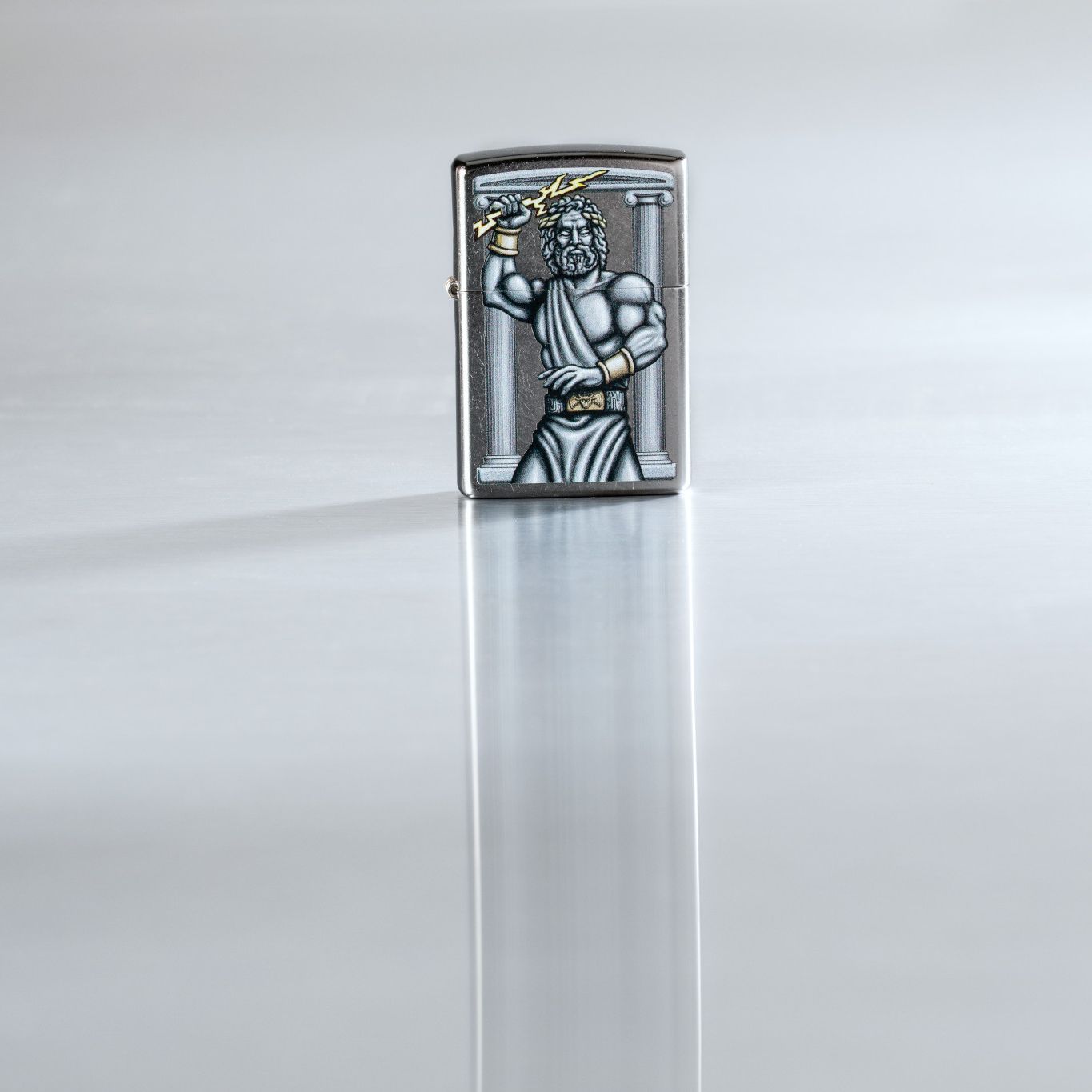 Lifestyle image of Zeus Design Street Chrome Windproof Lighter standing on a reflective surface