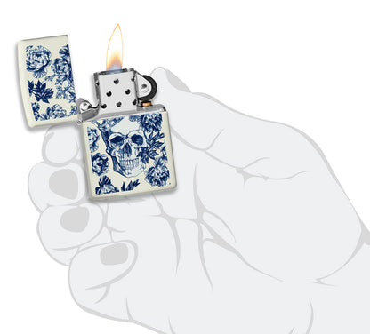 Zippo lighter glows in the dark skull with crown surrounded by blue flowers opened with flame in stylised hand