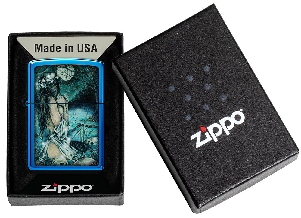 Zippo lighter glossy blue in mystical scenery with lightly dressed lady at the lake surrounded by skulls as well as crows in open box